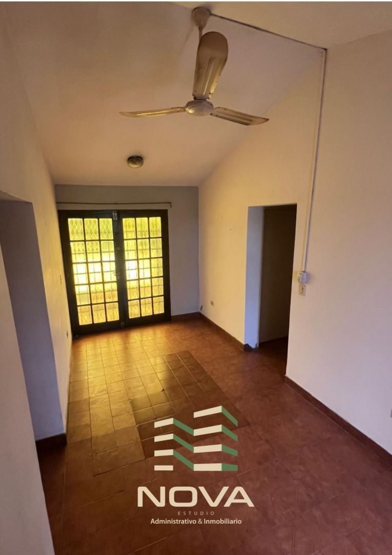 Sala de estar de la planta alta con puerta ventana y ventilador de techo