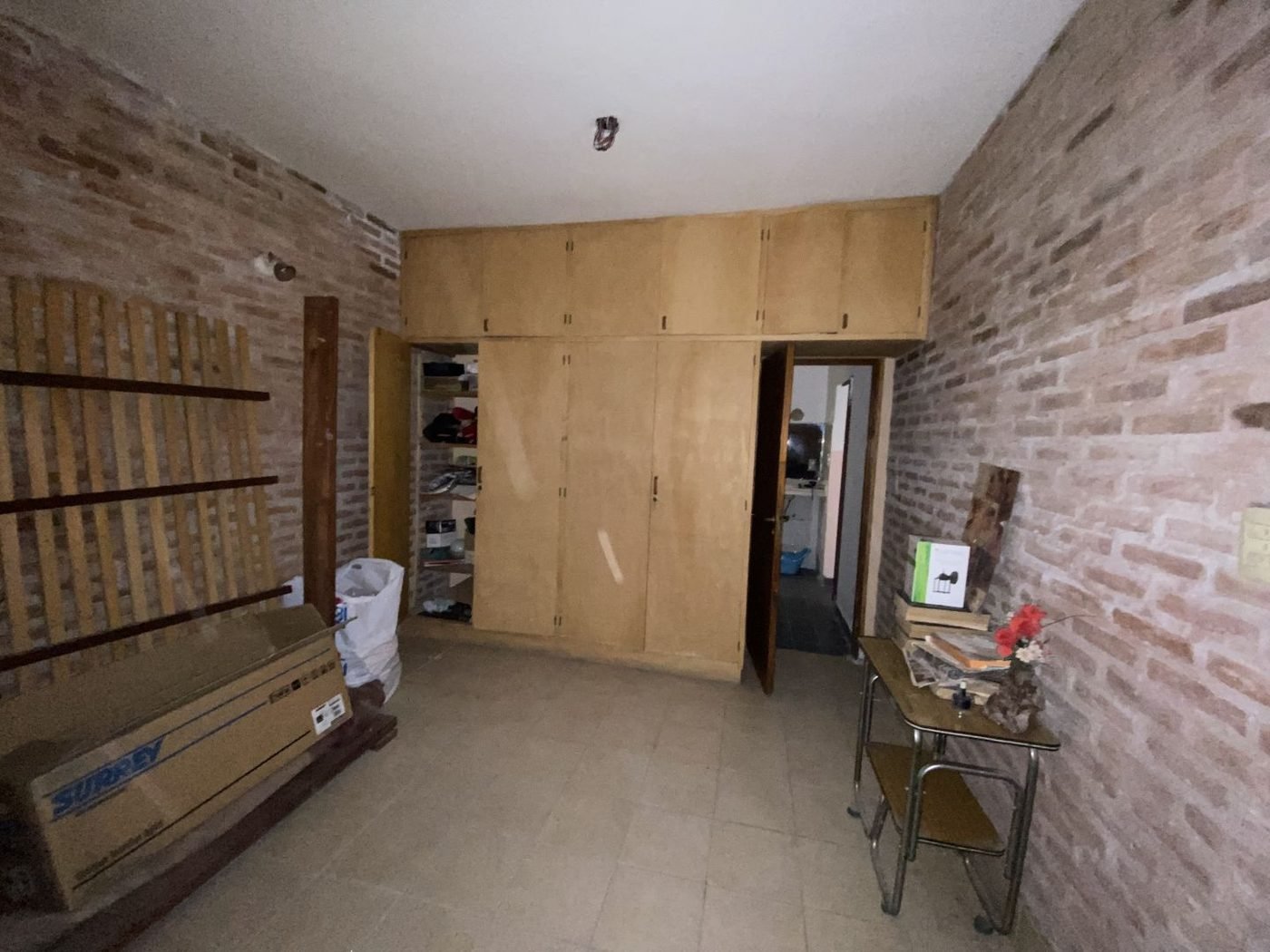 Dormitorio con paredes de ladrillo visto y placard